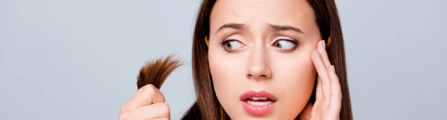 Besorgte Frau hält ihre Haare, Teil der Anti-Spliss Collection